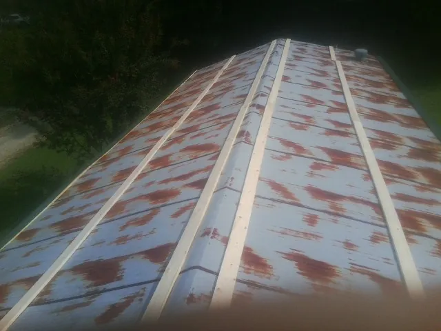 Rusted metal roof panels with new wood purlins before replacement — Storm Damage Roof Repair in Allen by Roofing Brothers